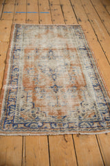 Worn pile of a Vintage Distressed Oushak rug, featuring faded apricot, royal blue floral patterns.