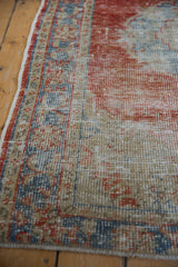 Vintage Distressed Oushak rug detail: soft, faded cherry red and pale blue, with textured wear.