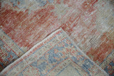 Textured pile of vintage distressed Oushak rug, showing foundation and hand-knotted reverse with selvage.