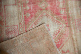 Hand-knotted foundation of the Distressed Oushak rug, revealing pink and beige geometric pile.