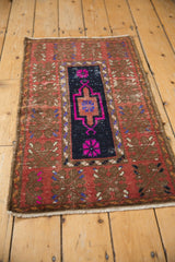 Distressed vintage Oushak rug showing even wear across its geometric navy and fuchsia design.