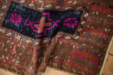 Close view of the even wear and low pile on a vintage Oushak rug with fuchsia floral designs.