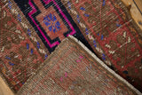 Corner of a vintage distressed Oushak rug, revealing the hand-knotted foundation and worn texture.