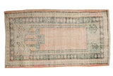 Distressed vintage Oushak runner with faded pale rose field and teal, ivory prayer design.