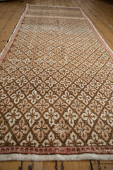 Repeating floral panel pattern on vintage distressed Oushak runner with blush selvage.