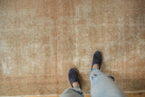 Distressed pile of a vintage Oushak runner with visible wear and faded neutral tones.