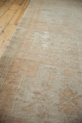 Distressed vintage Oushak rug pile with mostly even wear, beige tones, and intact selvage.