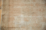 Distressed Oushak rug texture, showing mostly even wear and exposed foundation.