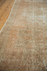 Distressed vintage Oushak runner pile, showing mostly even wear, beige tones, and intact selvage.