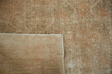 Distressed beige Oushak rug pile revealing the hand-knotted foundation.