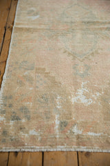 Distressed vintage Oushak rug close-up, showing low pile, foundation exposure, and pastel colors.