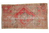 Distressed hand-knotted Oushak rug with faded red and muted geometric medallions, 2'10