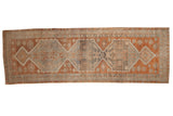 Distressed vintage hand-knotted Oushak runner with copper, charcoal, and beige geometric medallions. 3'2