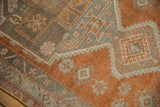 Distressed Oushak runner featuring copper, charcoal, and oxidized silver floral motifs.