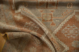 Distressed pile texture of a vintage Oushak rug, highlighting copper and silver geometric patterns with yellow side cord.