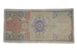 Distressed vintage Oushak rug mat, faded purple crab medallion, geometric motifs on beige.