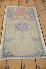 Geometric purple crab medallion, seafoam green motifs on distressed Oushak rug.