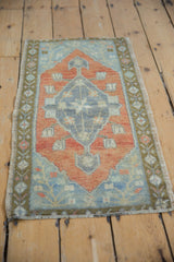 Vintage distressed Oushak rug mat with even wear, rust, and dusty blue medallion.