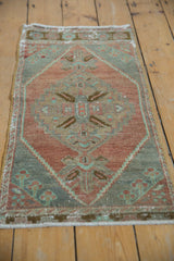 Textured pile of distressed Oushak rug showing mostly even wear and muted slate, aubergine.