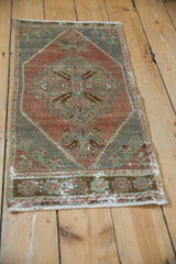 Detailed view of vintage distressed Oushak rug's side selvage, pattern, and wear to knot heads.