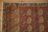 Corner of hand-knotted vintage Oushak rug, distressed pile, chestnut, ivory, and teal pattern.