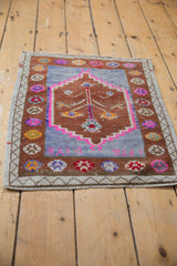 Distressed Oushak rug's central tree of life, pomegranate border, in copper, pink, and blue.
