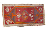 Vintage distressed Turkish Jijim rug with geometric guls in wine red, dusty violet, and tangerine.