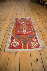 Vintage distressed Turkish Jijim rug with geometric floral guls, wine red, orange, violet.