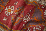 Textural hand weave of geometric guls and tangerine plant motifs on a vintage Jijim rug.