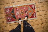 Vintage Turkish Jijim runner featuring geometric guls in warm red, orange, and charcoal tones.