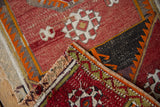 Hand-woven texture and geometric patterns on this vintage Jijim rug's folded corner.
