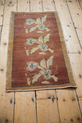 Textured vintage Oushak rug with copper field, softened by even wear, and faded floral designs.