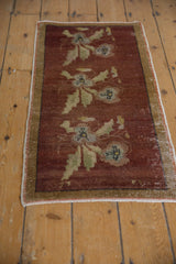 Distressed Oushak rug with worn side selvage, banded border, and copper floral motifs.