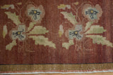 Distressed copper, beige, and green floral pattern and banded border of vintage Oushak rug.