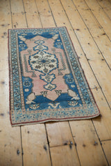 Distressed vintage Oushak runner, pale sapphire blue floral border, dusty rose field.