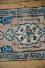Distressed vintage Oushak runner border detail featuring pale sapphire blue florals and dusty rose.
