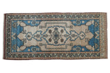 Distressed vintage Oushak runner with pale sapphire blue medallion, pearl-adorned ivory field.