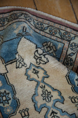 Soft, distressed pile texture of a vintage Oushak rug in pale sapphire blue and ivory.