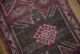 Distressed Oushak rug pile with fuchsia and silver diamond gul pattern.
