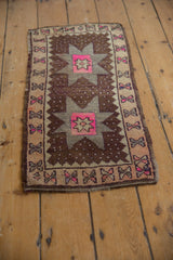 Distressed vintage Oushak rug with pink floral starburst medallion, even pile wear.