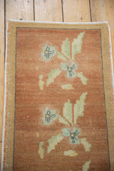 Distressed copper Oushak rug field with powder blue and seafoam green floral sprays.