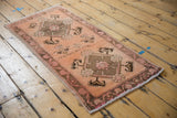 Vintage distressed Oushak runner with soft terracotta pile and faded raspberry border.