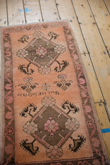 Distressed vintage Oushak runner with terracotta, faded raspberry, and brown floral medallions.