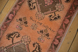 GULHEJDAR weaver name with faded floral motifs on pale terracotta Oushak runner.