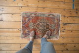 Distressed Oushak rug mat with madder root, royal blue, ivory tones, showing even wear underfoot.