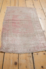 Distressed Oushak rug texture, short pile, muted rose, and secured side and end.