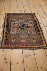 Primitive geometric floral medallion and pinwheel motifs on distressed Oushak rug in coffee, saffron, pink.