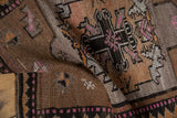 Distressed Oushak rug texture with geometric motifs in coffee brown, charcoal, saffron, pink.