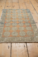 Worn geometric floral field and vine main border of this distressed vintage Oushak rug.