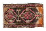 Hand knotted distressed vintage Oushak mat with vibrant pink double medallion and tangerine corners.